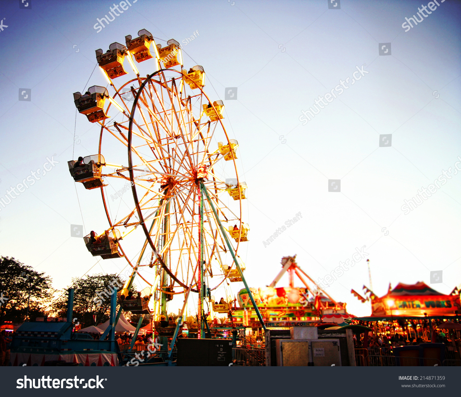 a fair ride during dusk on a warm summer evening #214871359