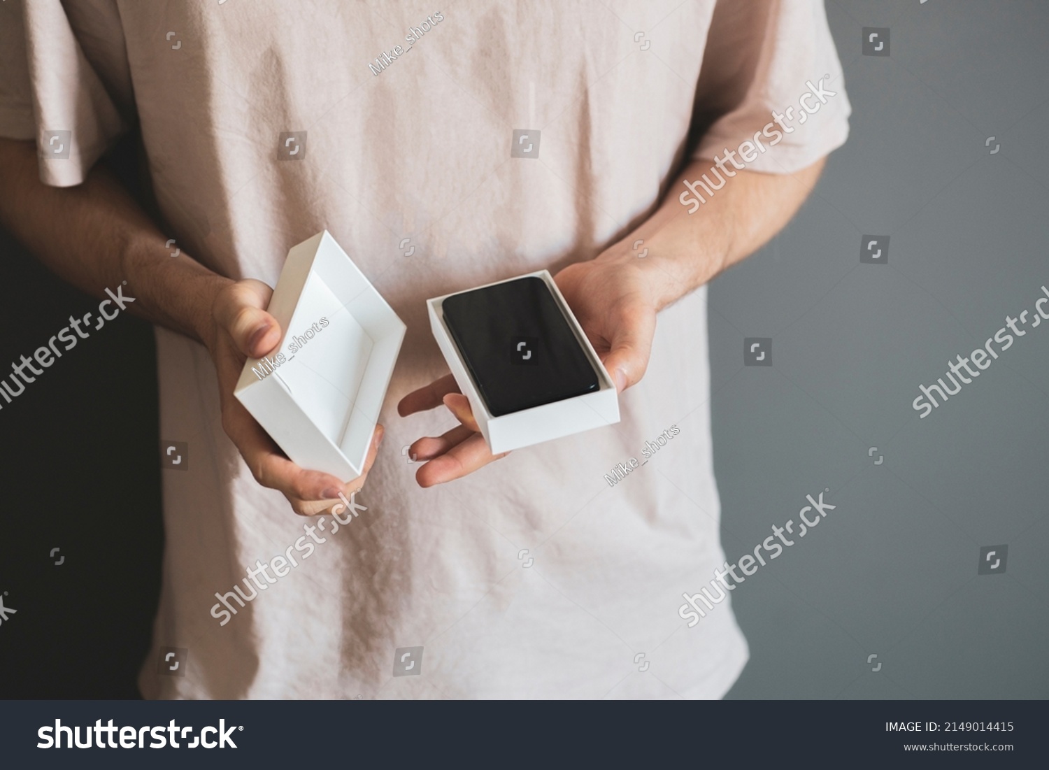 person holds the new smartphone box or case and unpack it, holiday surprise present concept #2149014415