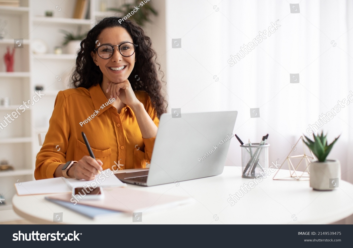 Happy Brunette Business Lady Using Laptop Smiling To Camera Posing Wearing Glasses Working Sitting At Workplace In Modern Office. Successful Entrepreneurship And Career Concept #2149539475