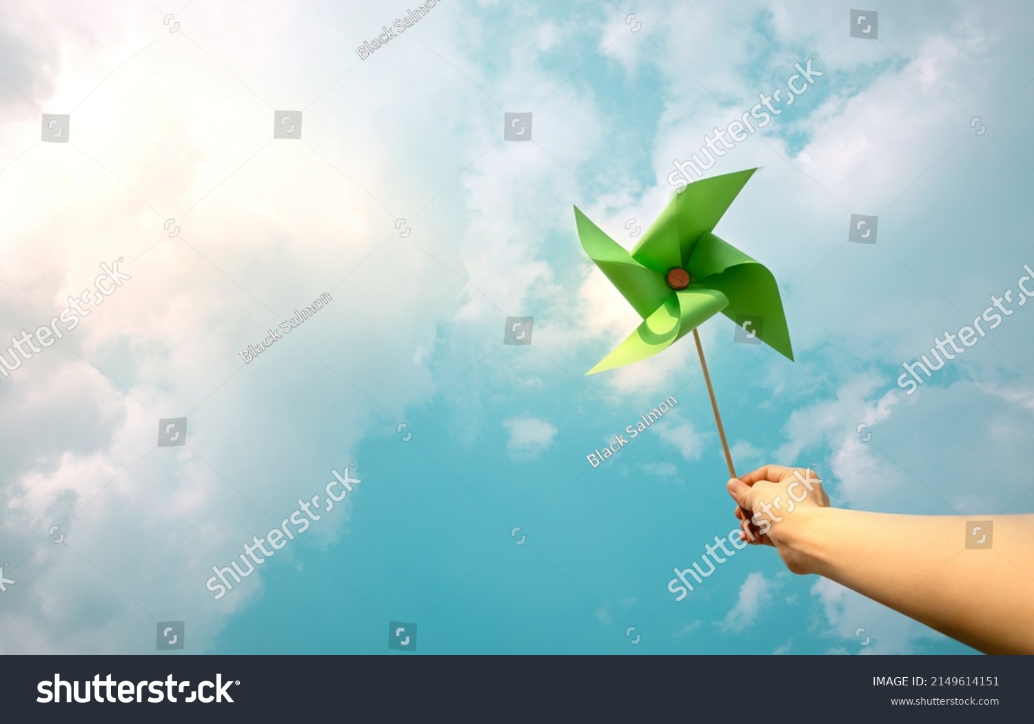 ESG and Clean Energy Concept. Hand Raise up a Wind Turbine Paper into the Sky. Decrease Carbon and Produce a Green Power. World Earth Day, Sustainable Resources, Environmental Care #2149614151