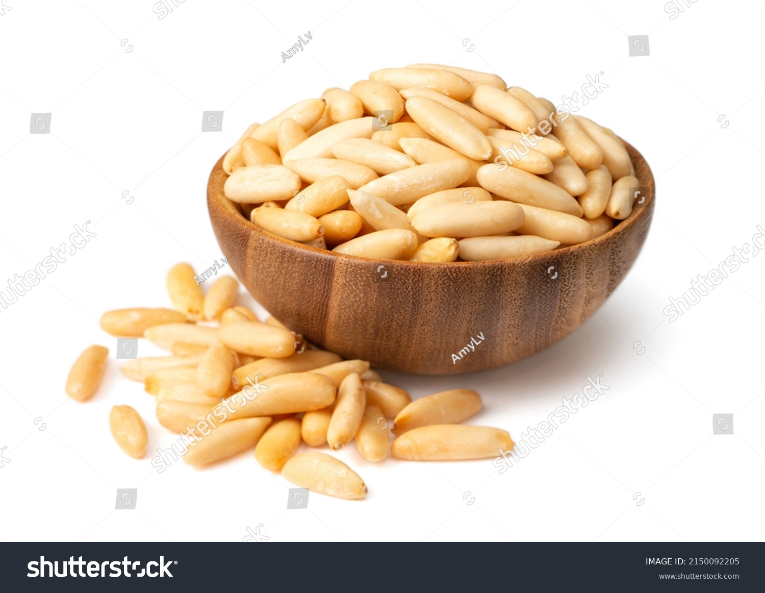 Roasted pine nuts in the wooden bowl. isolated on white background. #2150092205