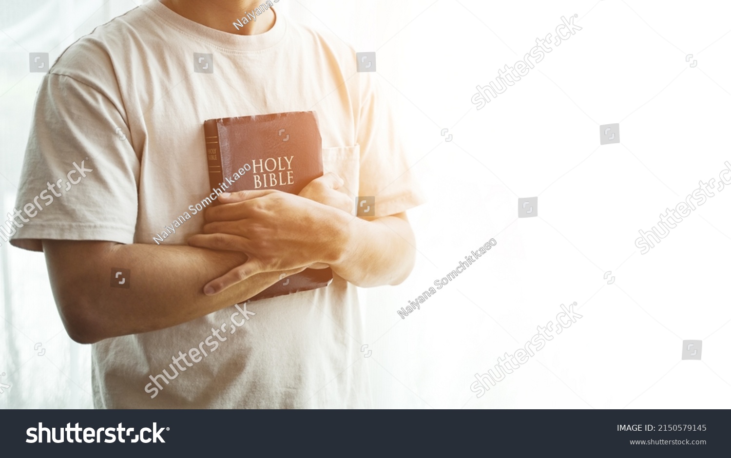 The Bible is in hand, praying by hand and praying together. with religious faith and belief in god on blessing background The power of hope or love and devotion. #2150579145