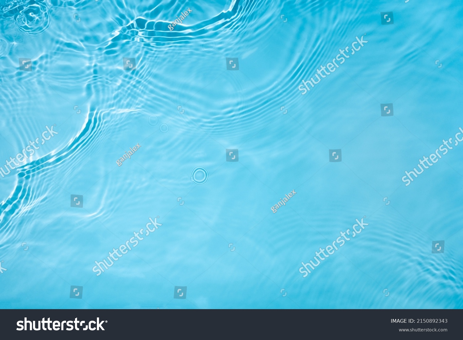 Transparent blue clear water surface texture with ripples, splashes and bubbles. Abstract nature background Water waves in sunlight. Cosmetic moisturizer micellar toner emulsion. Top view, copy space #2150892343