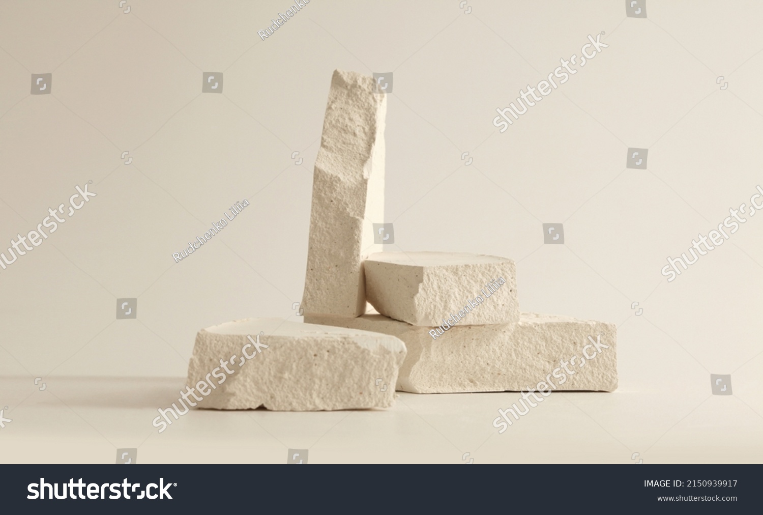 Empty stack of stones platform podium on beige background. Minimal empty display product presentation scene. #2150939917