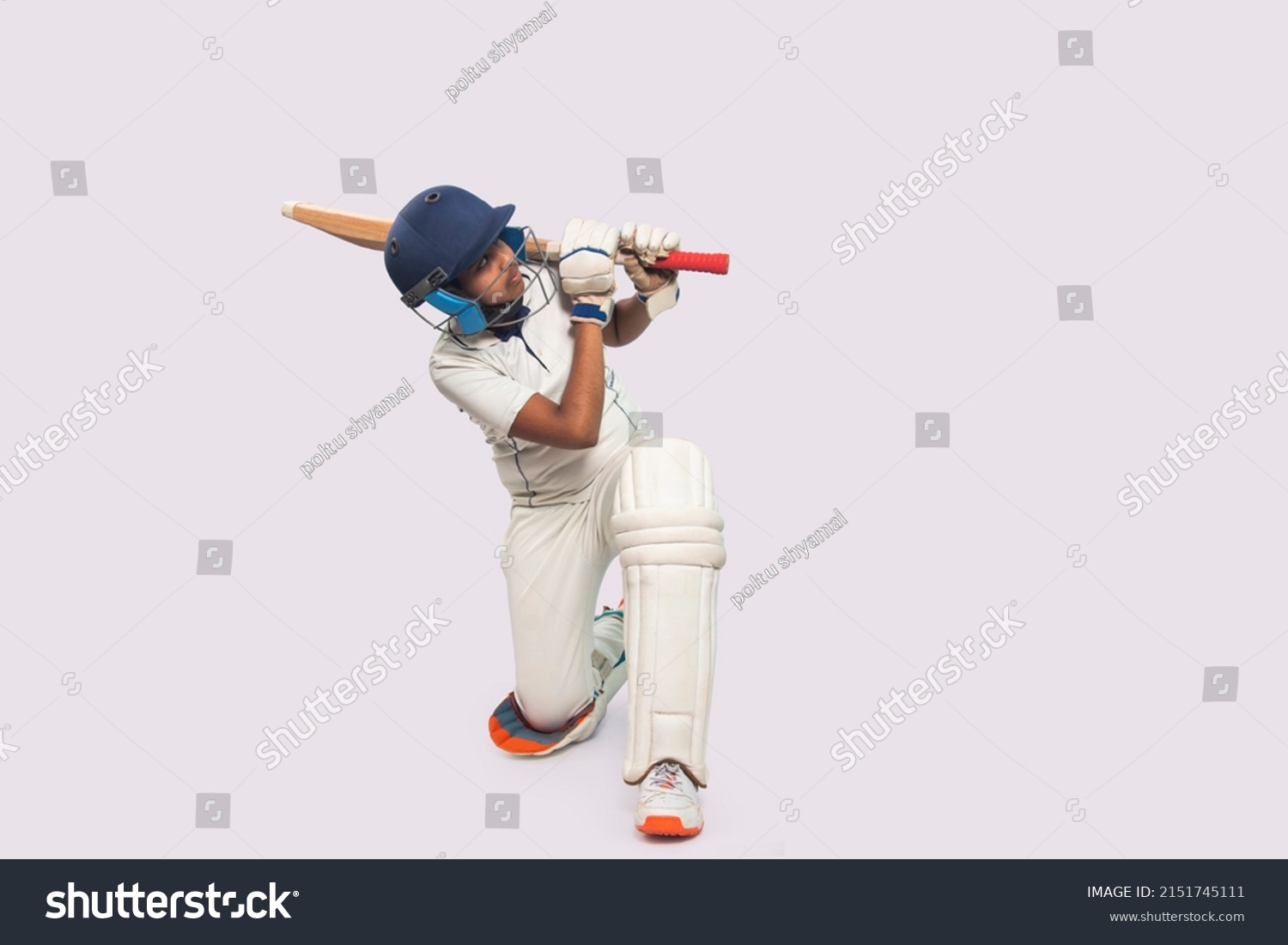 Portrait of boy hitting a shot During a Cricket Game #2151745111