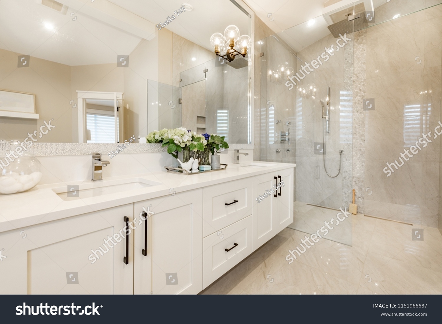 Spacious master bathroom with glass wall shower free standing bathtub large mirrors toilet with privacy wall and white cabinets #2151966687