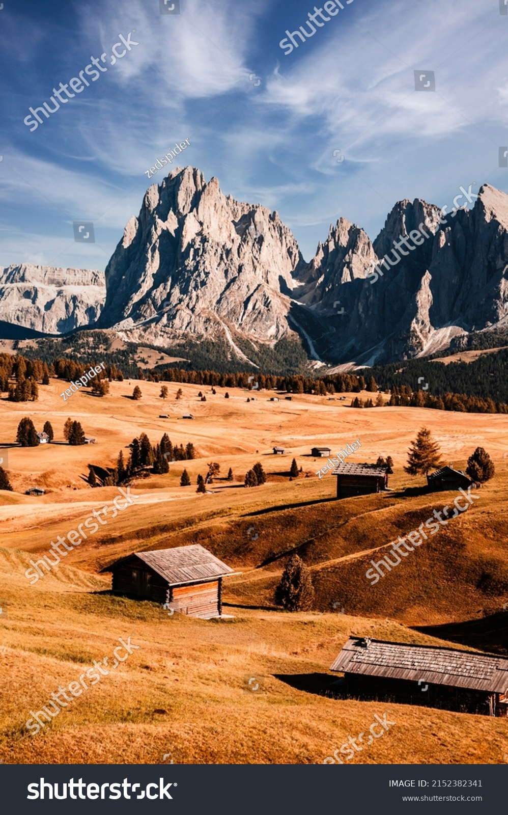 Alpe di Siusi - Seiser Alm- Langkofel mountain group. landscape of Alpine red autumn Alpe di Siusi. hiking nature scenery in dolomites. wooden chalets in Dolomites, Trentino Alto Adige #2152382341