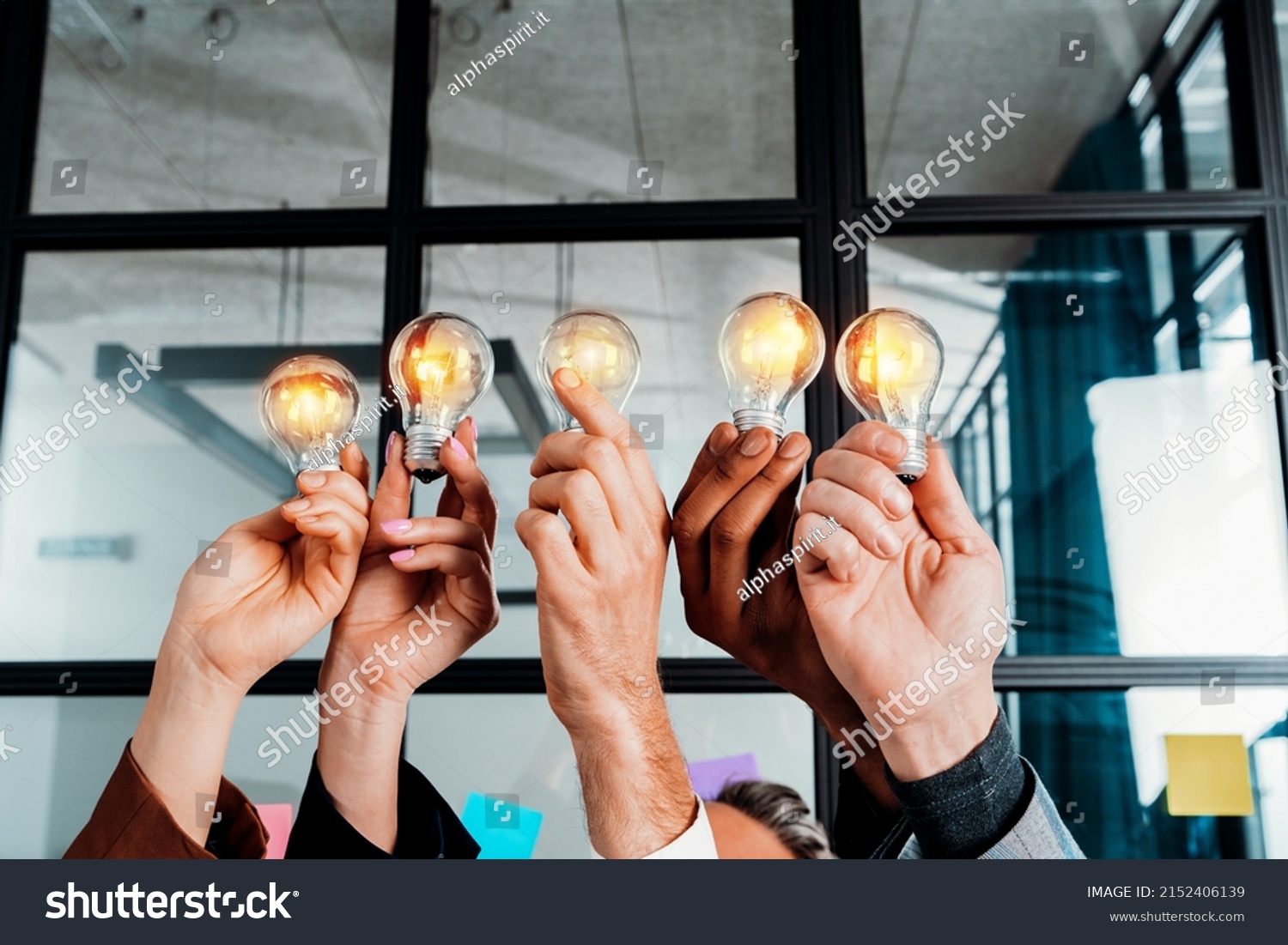 Teamwork and brainstorming concept with businessmen that share an idea with a lamp #2152406139