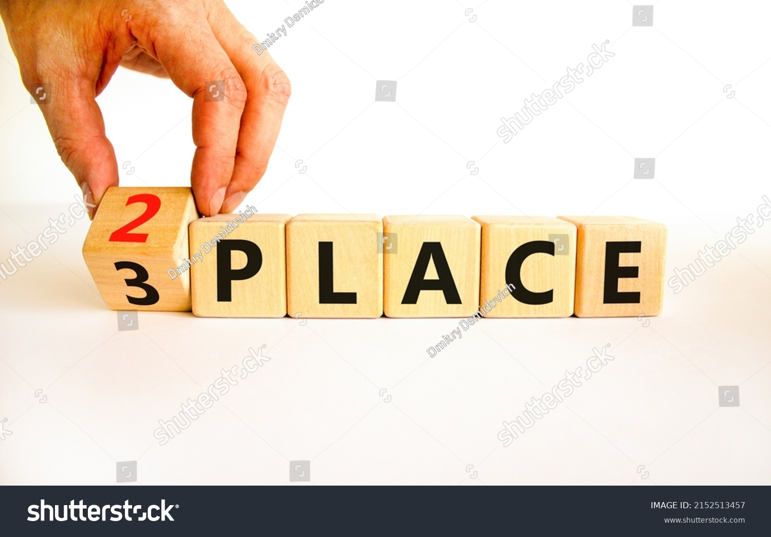 From 3 to 2 place symbol. Businessman turns wooden cubes and changes concept words 3 place to 2 place. Beautiful white table white background. Business and from 3 to 2 place concept. Copy space. #2152513457