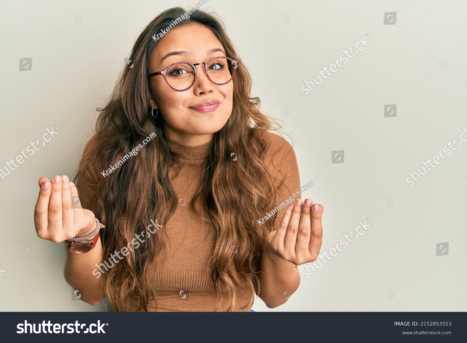 Young hispanic girl wearing casual clothes and glasses doing money gesture with hands, asking for salary payment, millionaire business  #2152853553