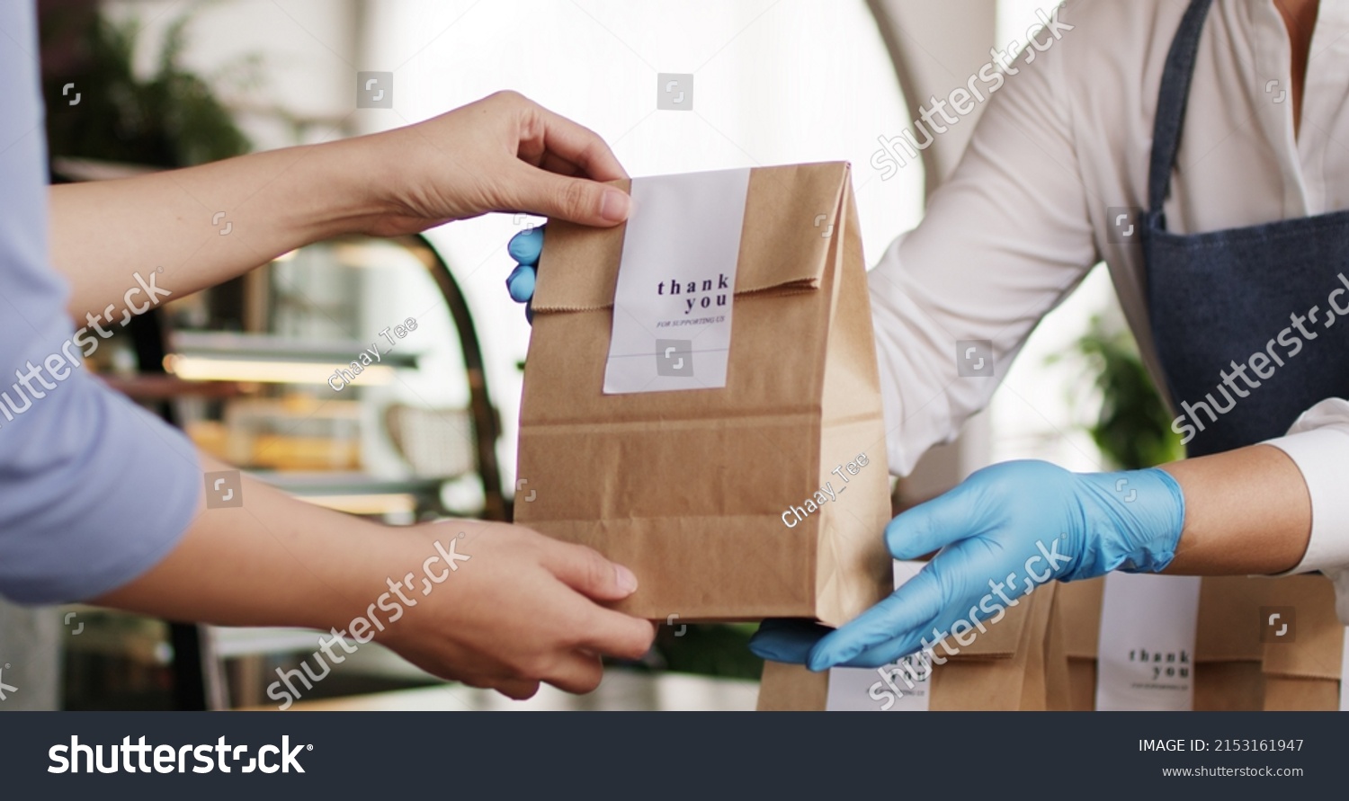 Asia people woman hand glove or face mask happy enjoy buy fast food carry send paper box pick up take home to-go lunch meal. Small cafe coffee shop work with wrap care new normal for SME omni channel. #2153161947