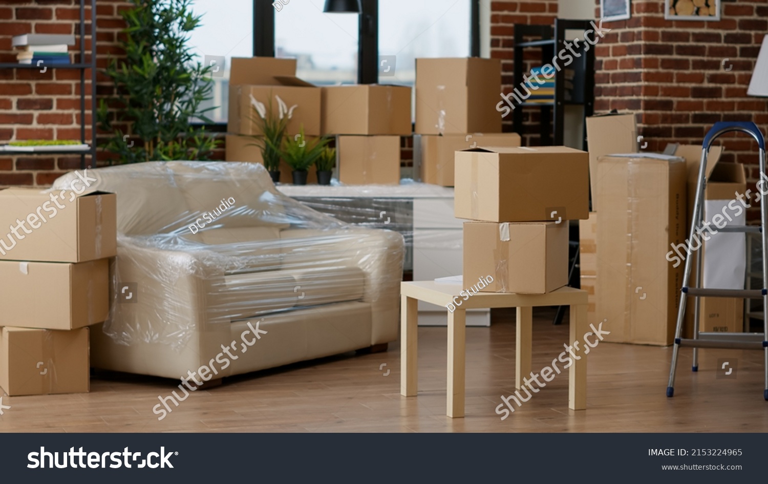 No people in empty living room apartment with carton boxes on stack, moving cardboard storage packaging in new household. Nobody in relocation property with interior furniture cargo. #2153224965