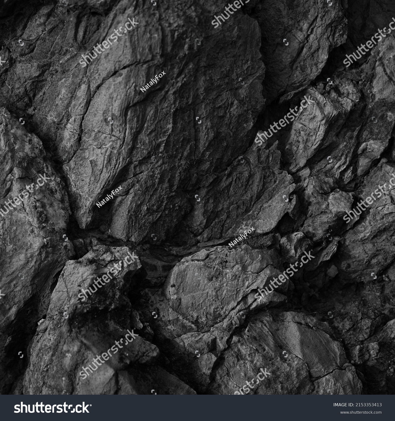   Black white rock texture. Rough mountain surface. Close-up. Dark volumetric stone background with space for design. Crumbled. Weathered.                               #2153353413