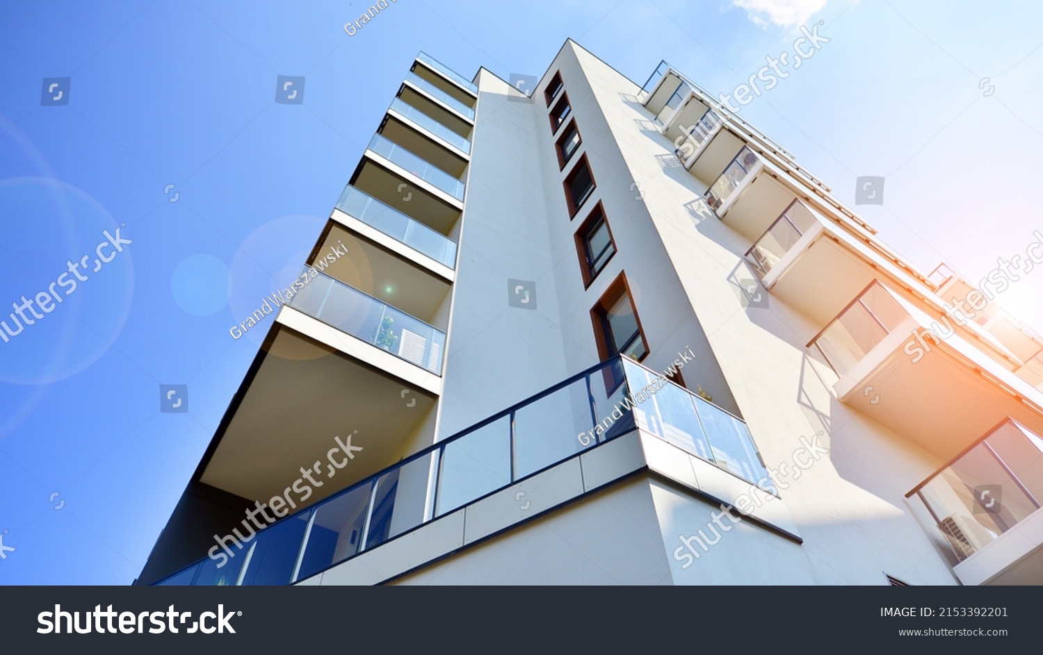 Modern luxury residential flat. Modern apartment building on a sunny day. Apartment building with a blue sky. Facade of a modern apartment building. #2153392201