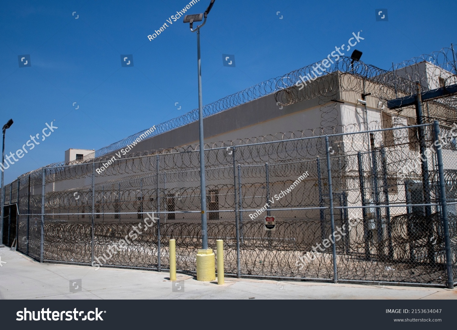 San Pedro California Federal Correctional Institution Terminal Island prison exterior. Prison fence and razor wire  #2153634047