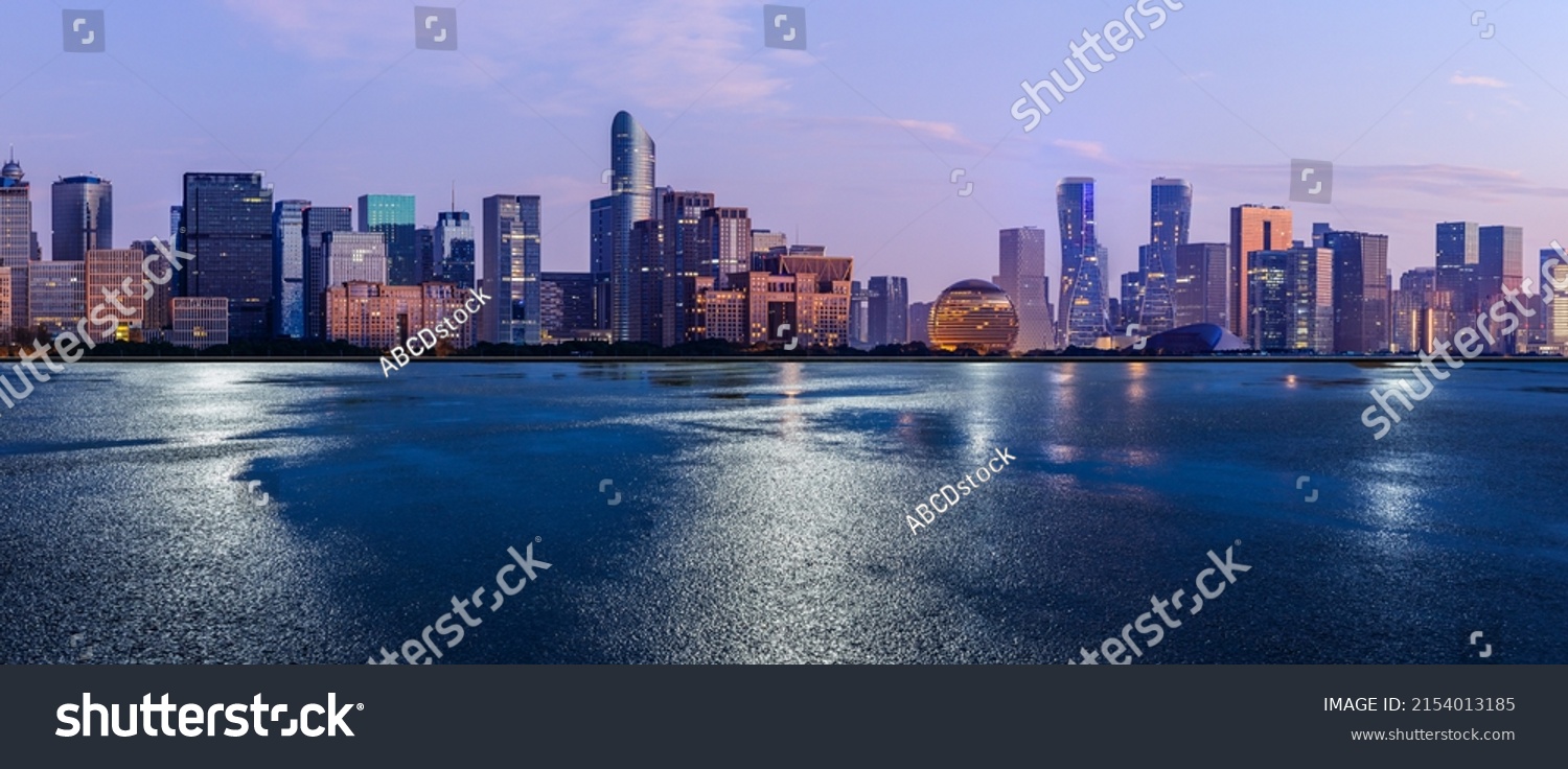 Asphalt road and city skyline with modern commercial buildings in Hangzhou at night, China. #2154013185