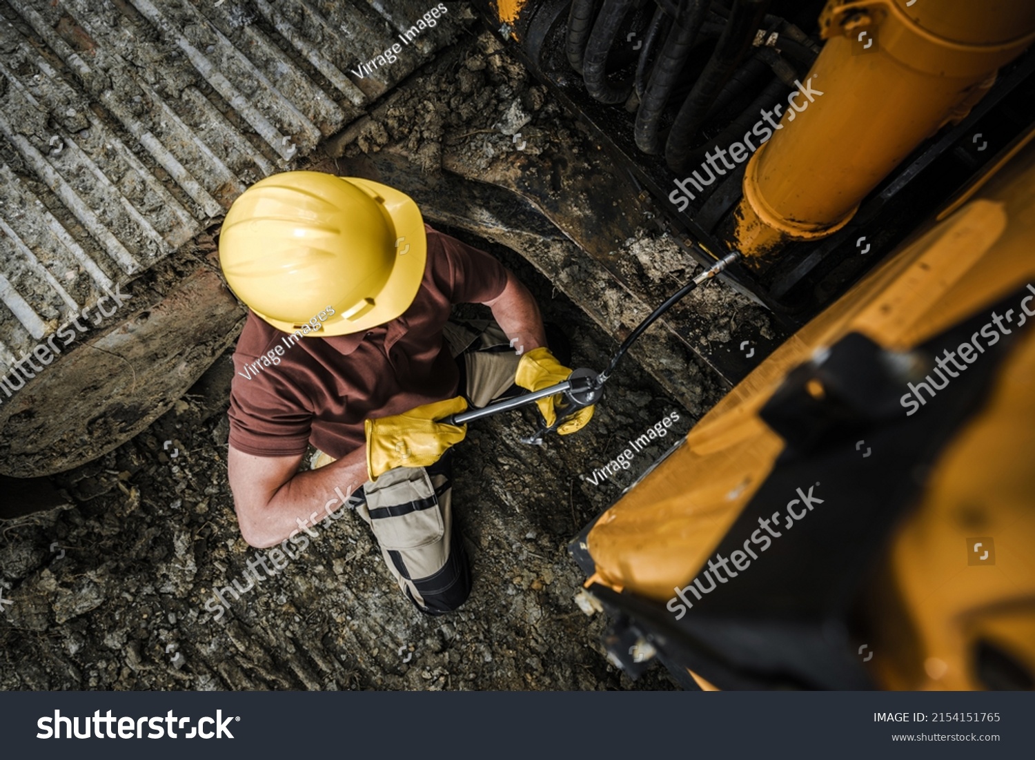 Professional Dozer Operator Worker Lubricating Greasing Points Inside a Heavy Equipment Crawler Machine. Bulldozer Grease Maintenance. #2154151765
