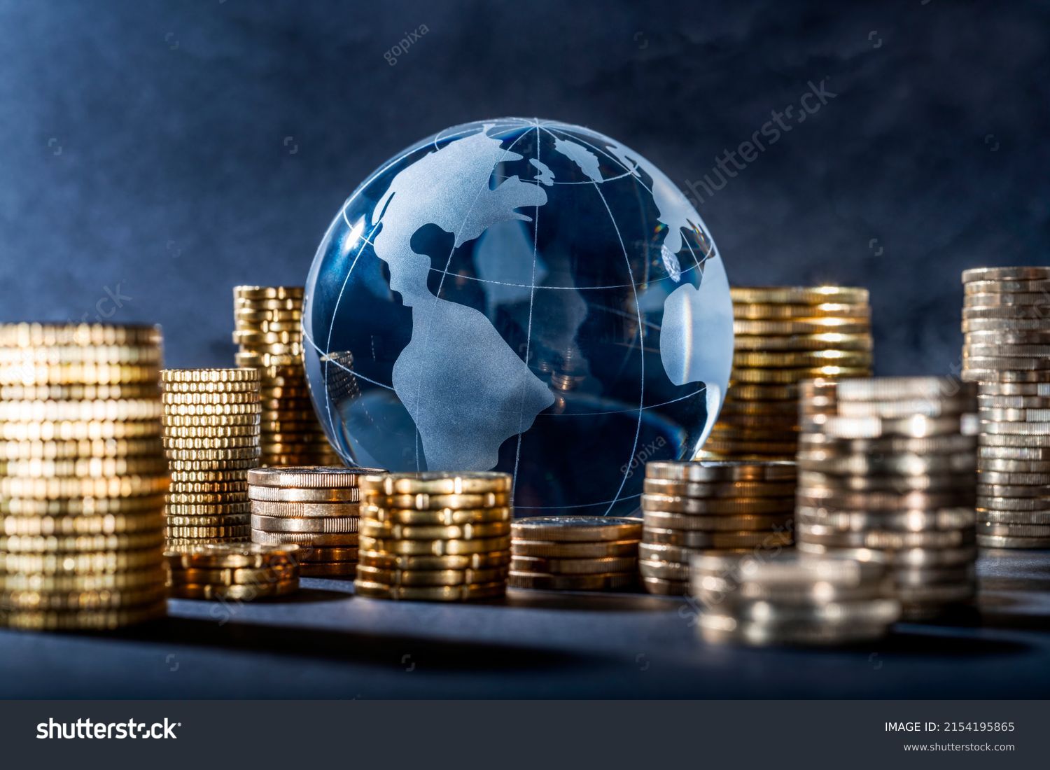 Globe and stack with coins. Money makes the world go round #2154195865