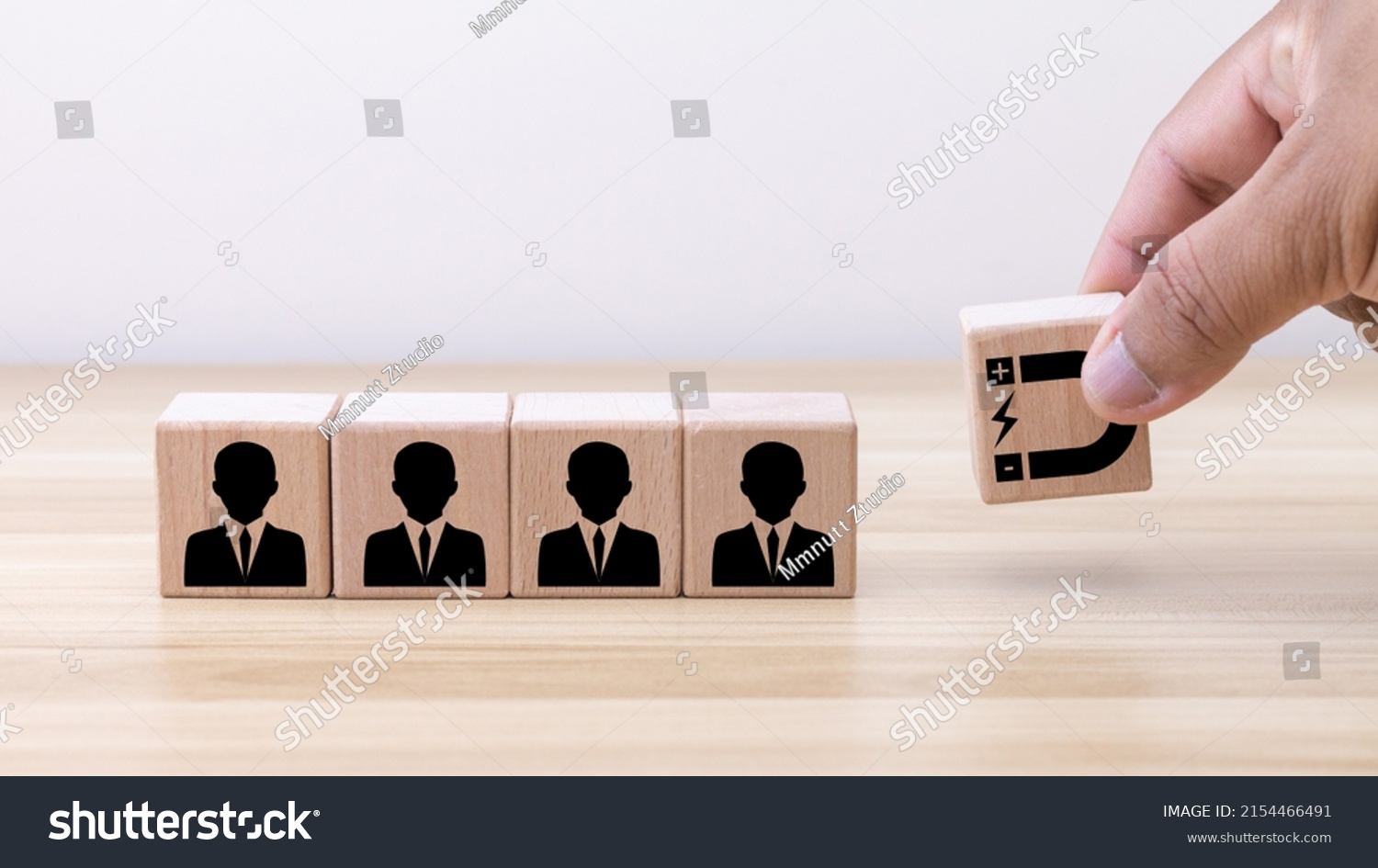 Customer retention concept. Inbound marketing strategy. Attracting potential customers. Hand puts wooden cubes with magnet attracts customer icons on beautiful grey background and copy space. #2154466491