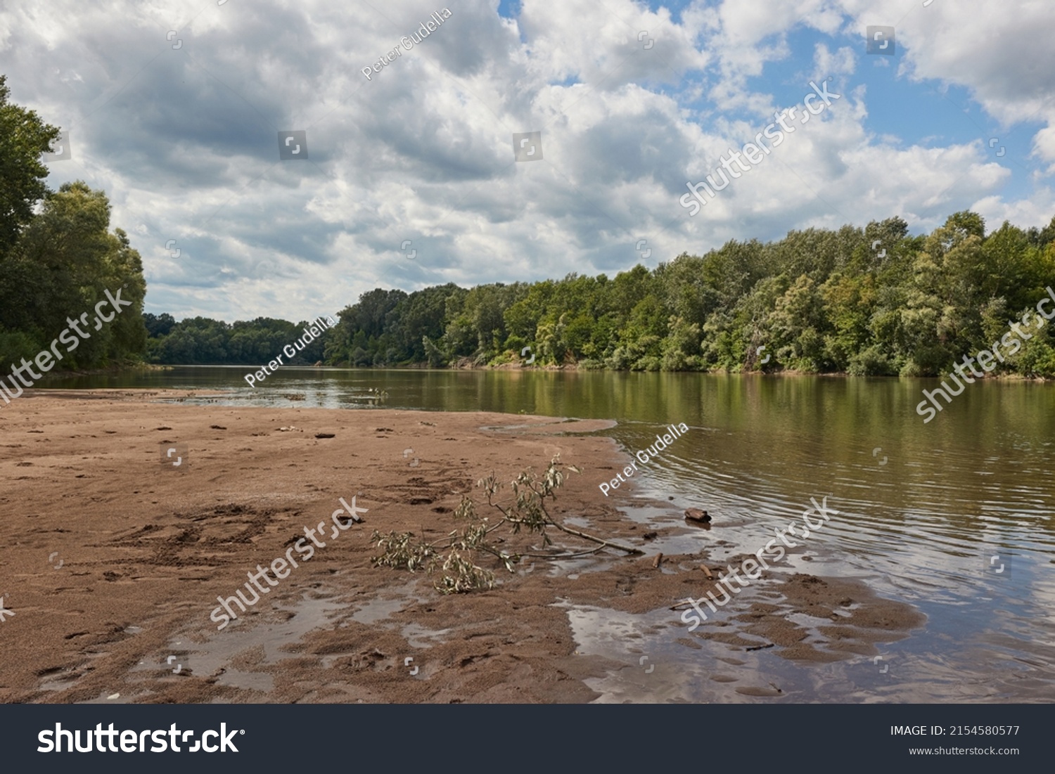 River landscape with sand bank appearing on the shore at low water levles. River Tisza, Hungary #2154580577