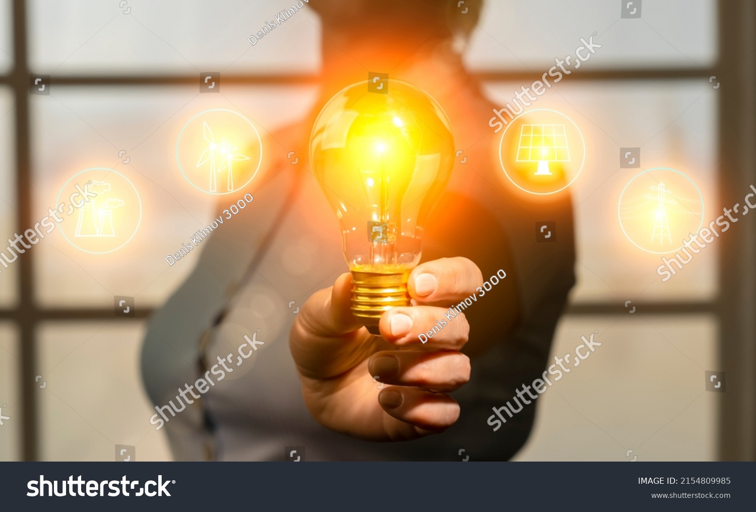 Concept of energy saving, rational use of natural resources and development of renewable energy sources. Woman in hand holding light bulb with electricity generation icons #2154809985