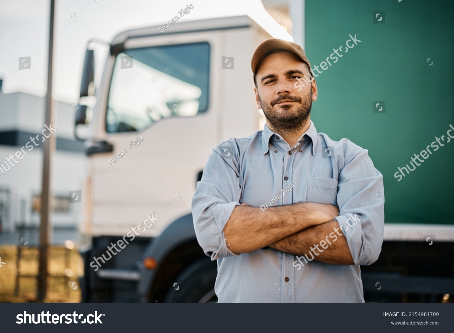 Portrait of confident truck driver on parking lot looking at camera. Copy space. #2154981709