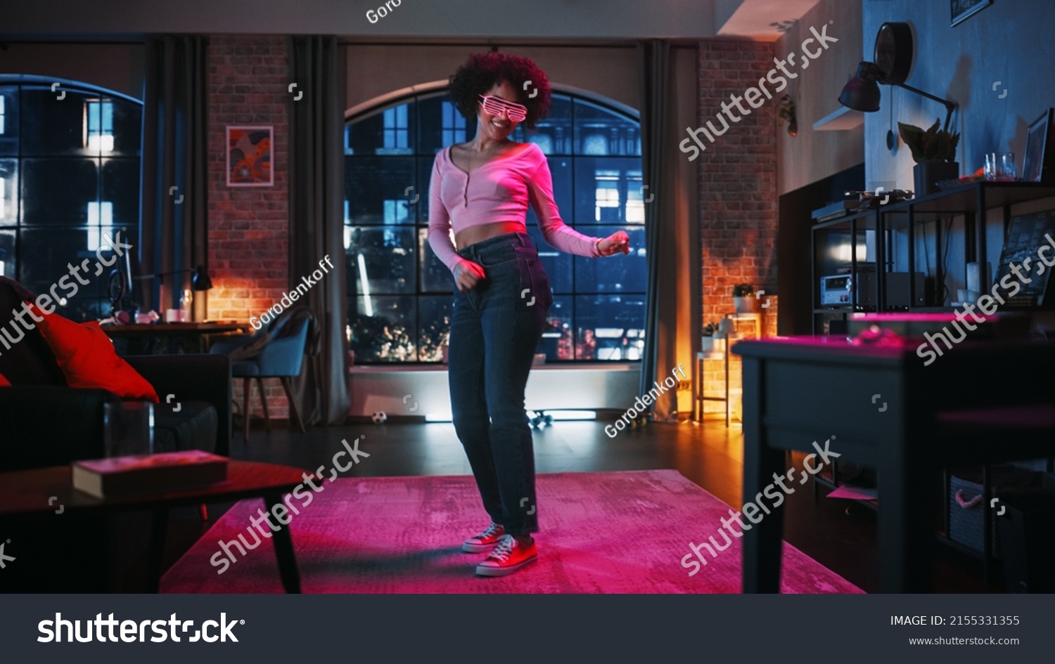 Portrait of Diverse Multiethnic Young Latin Female Dancing in Futuristic Neon Glowing Glasses, Having a Party at Home in Loft Apartment. Recording Funny Viral Videos for Social Media. #2155331355