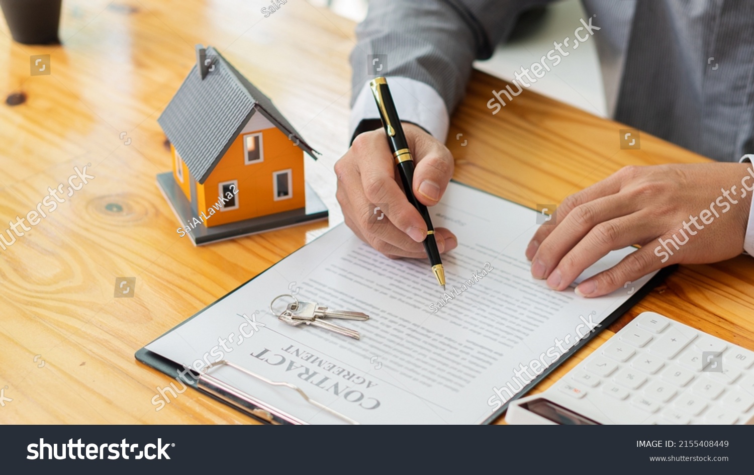 Businessmen holding pens, signing home titles with insurance, care about real estate services and the idea of real estate agents offering interest in installments to their customers. #2155408449