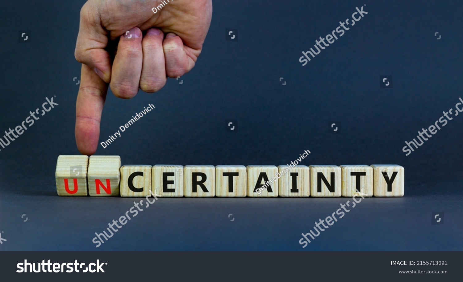 Certainty or Uncertainty symbol. Businessman turns wooden cubes and changes concept words Uncertainty to Certainty. Beautiful grey background. Business Certainty or Uncertainty concept. Copy space. #2155713091