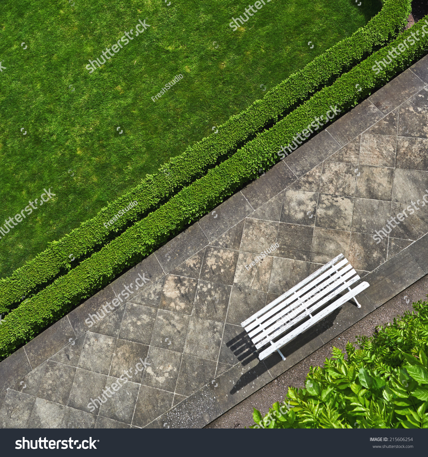 Geometric background with a white bench in a green park. Top view #215606254