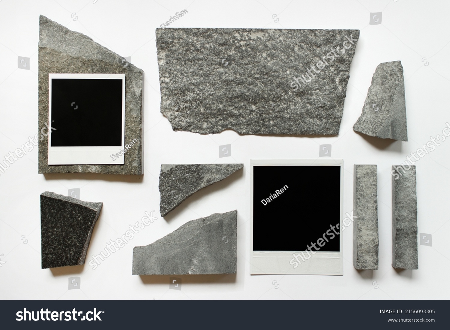 Abstract composition with two polaroid cards and random sized stones on white background. #2156093305