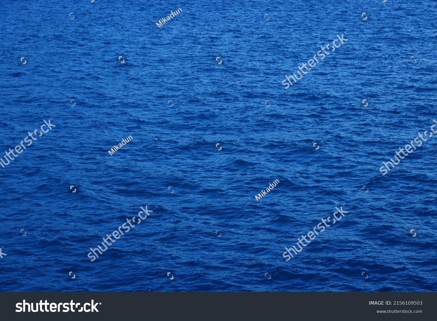 Blue water background. Ripple sea ocean water surface. still calm sea ocean water surface. close up blue water surface at deep ocean. Light blue background #2156109503