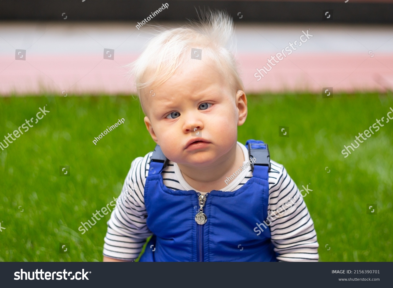 little baby boy portrait of child outdoor with strabismus eyes #2156390701