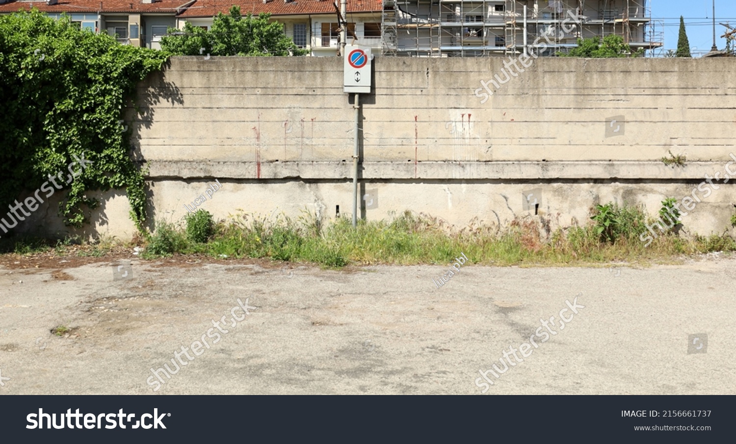 No stopping sign on a grunge concrete wall in a desolate urban road, Background for copy space. #2156661737