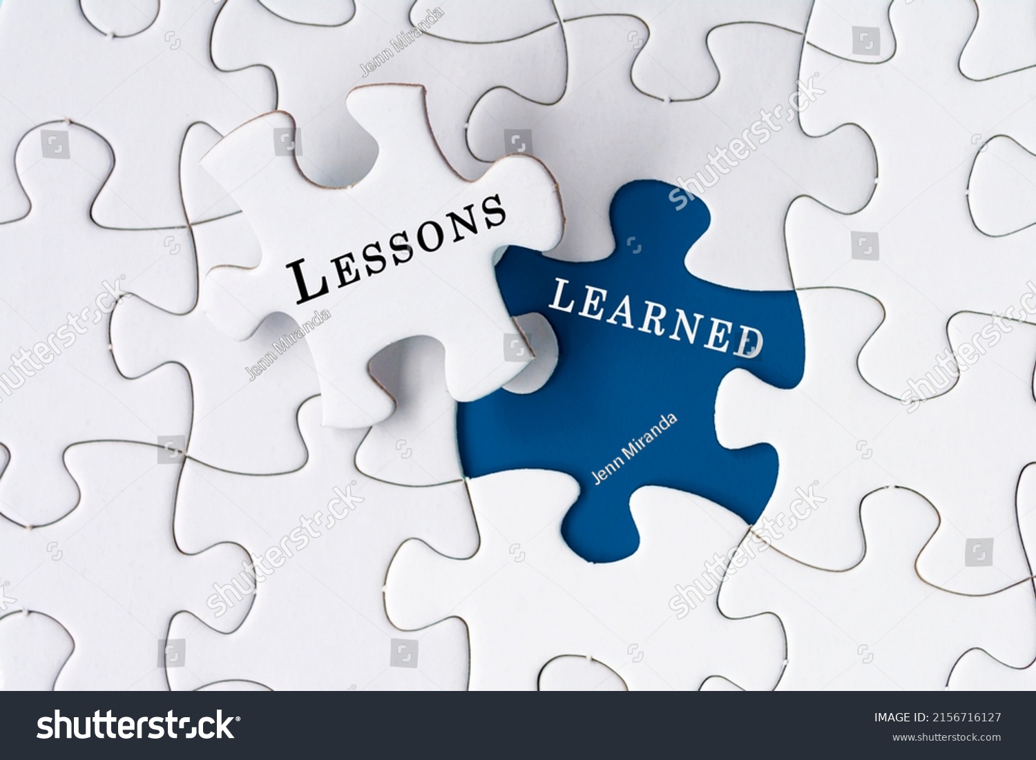 Lessons learned text on Jigsaw Puzzle over dark blue background. #2156716127