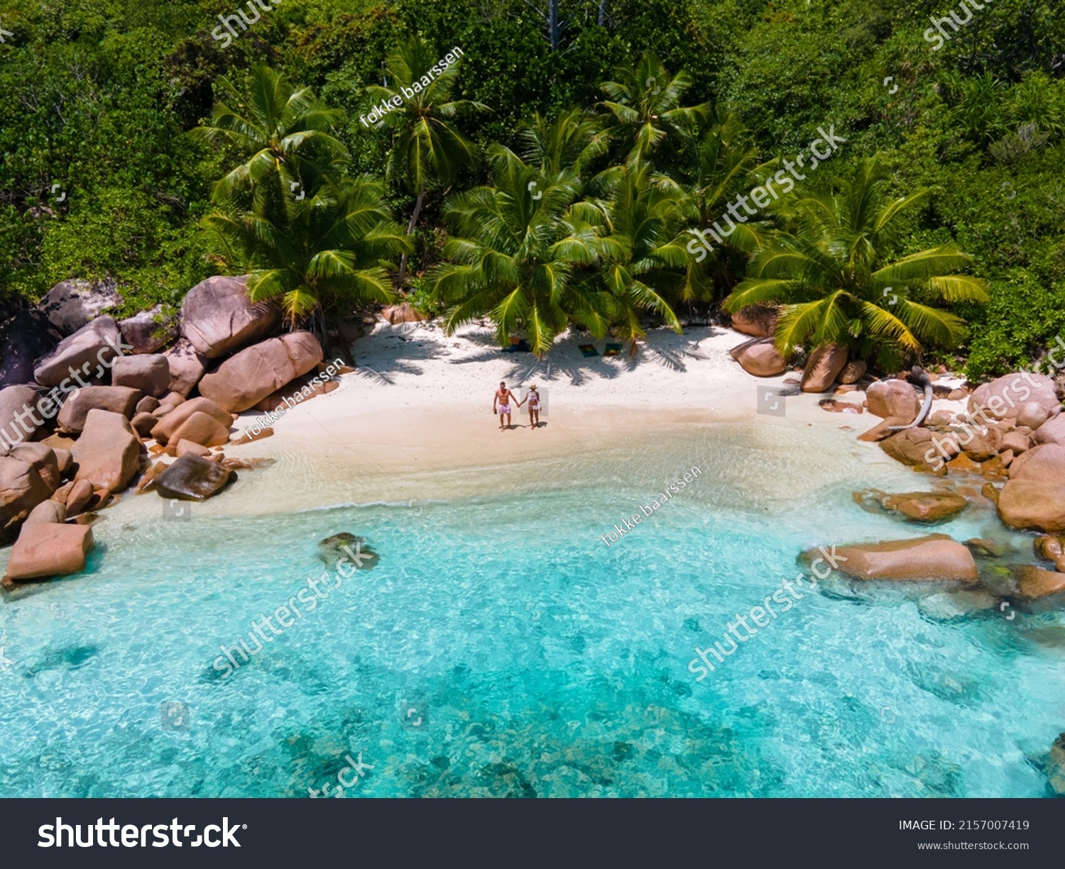 Anse Lazio Praslin Seychelles, a young couple of men and women on a tropical beach during a luxury vacation in Seychelles. Tropical beach Anse Lazio Praslin Seychelles #2157007419