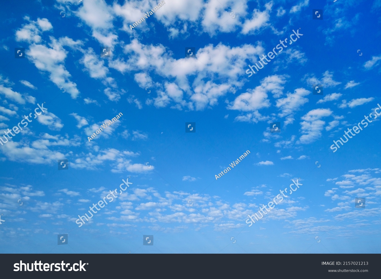 Summer sky. White clouds in the blue sky. Heaven and infinity. Beautiful bright blue background. Light cloudy, good weather. Curly clouds on a sunny day. #2157021213