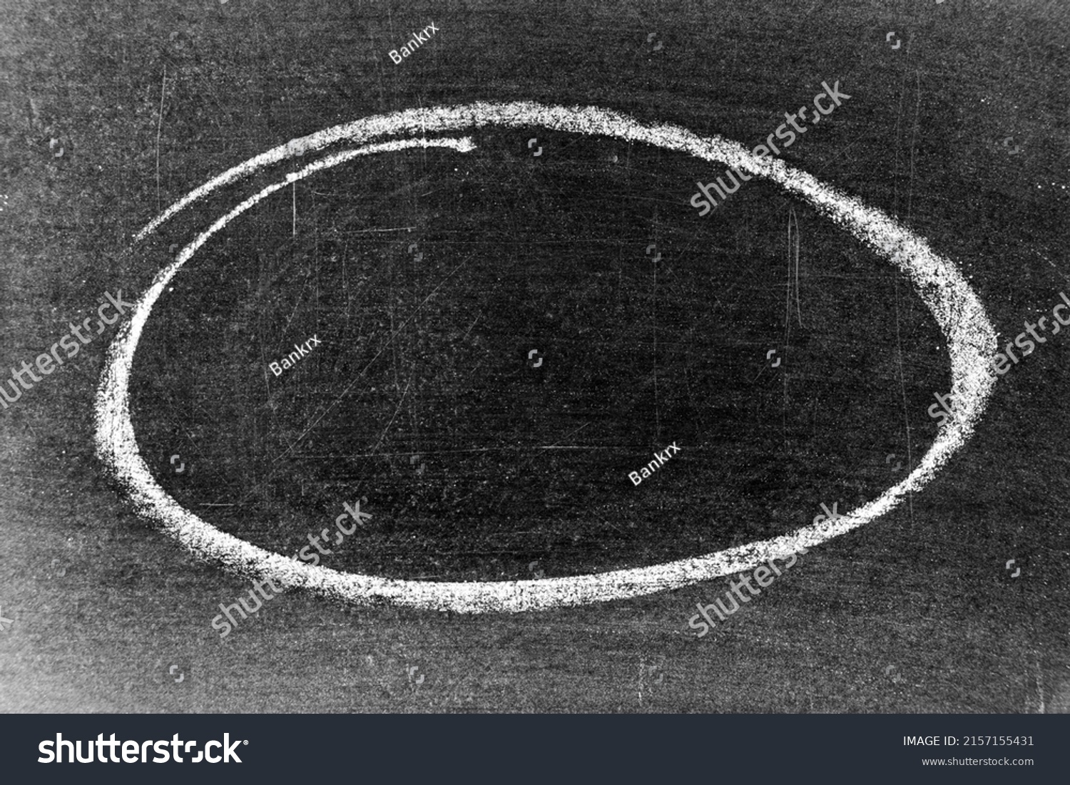 White chalk hand drawing as circle or round shape on blackboard or chalkboard background with copy space #2157155431