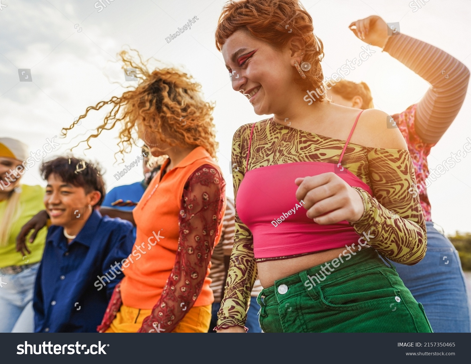 Happy young people dancing outdoor at festival event - Party and entertainment concept - Focus on right girl shoulder #2157350465