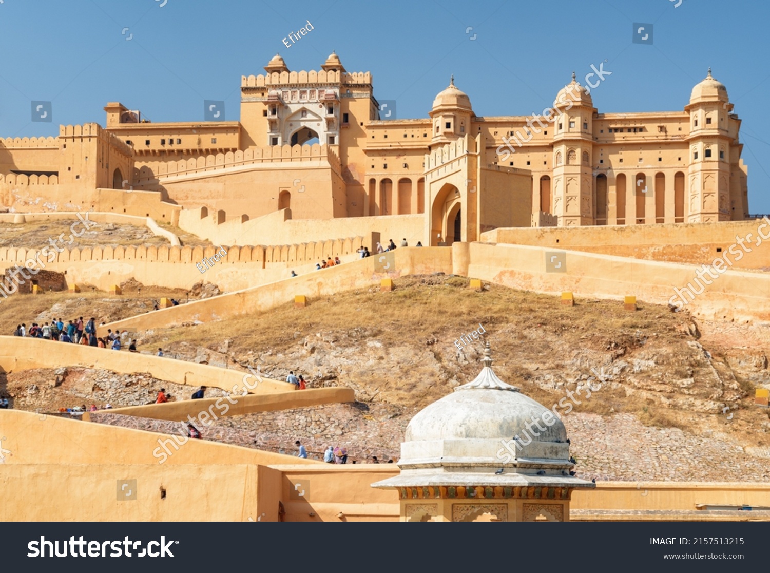 Gorgeous view of the Amer Fort and Palace (Amber Fort) on blue sky background in Jaipur, Rajasthan, India. Rajput military hill architecture. Jaipur is a popular tourist destination of South Asia. #2157513215