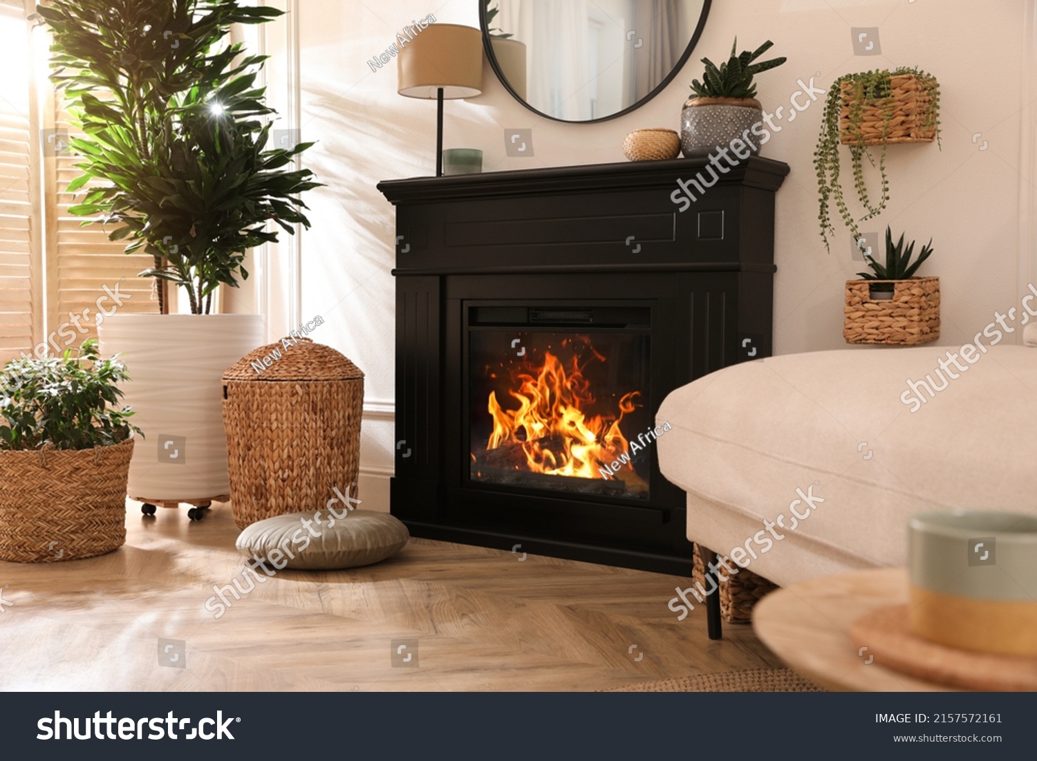 Stylish room interior with electric fireplace and beautiful decor elements #2157572161