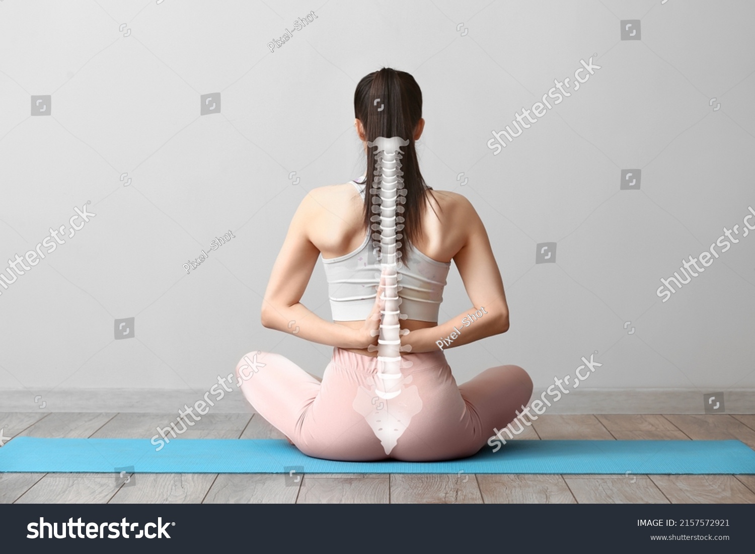 Young woman practicing yoga in gym. Concept of healthy spine #2157572921