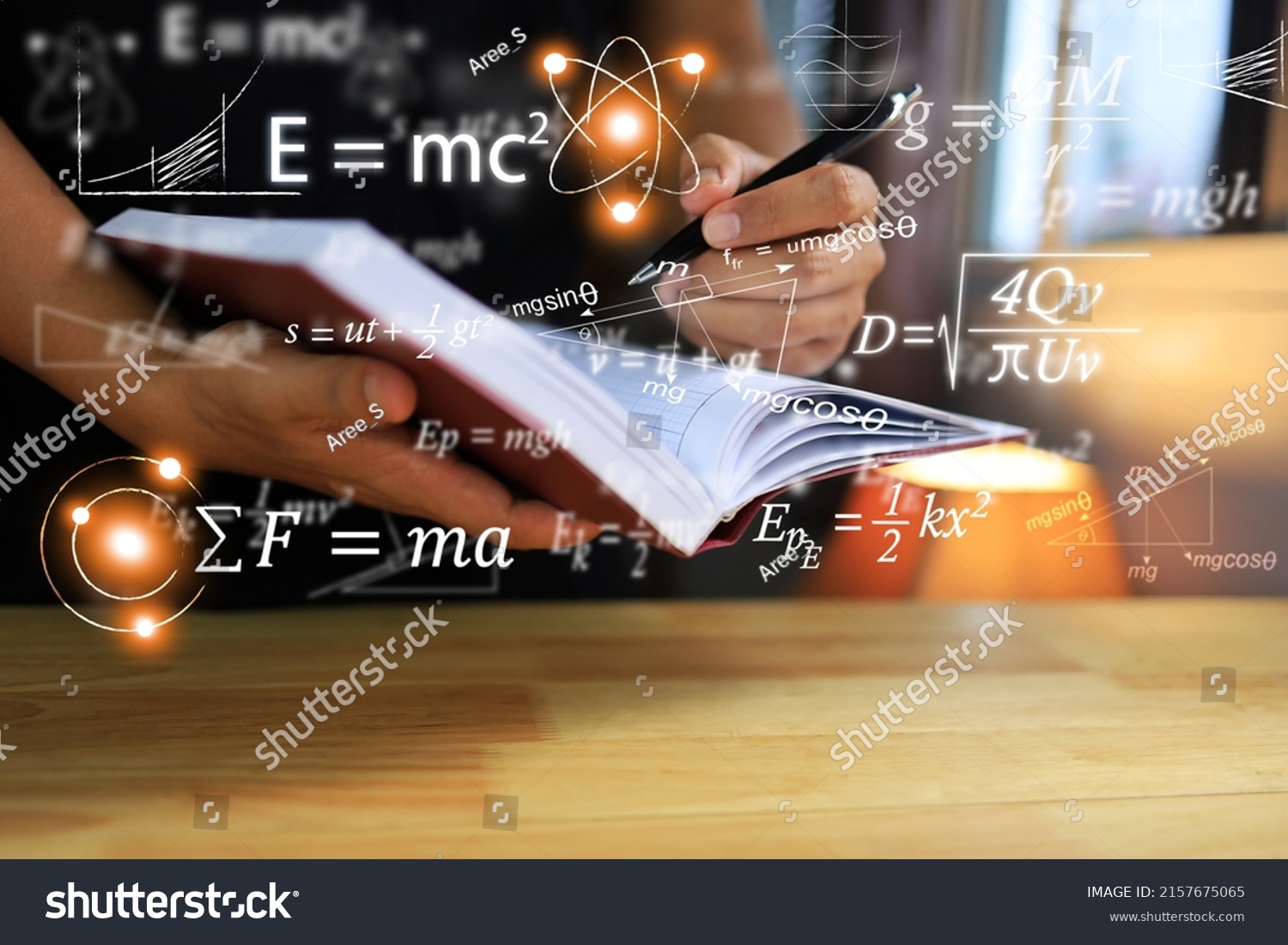 Physics equations floating in the background, hands writing in notebooks on wooden tables, representing the learning teaching or scientific notes of Albert Einstein and Sir Isaac Newton or physics all #2157675065