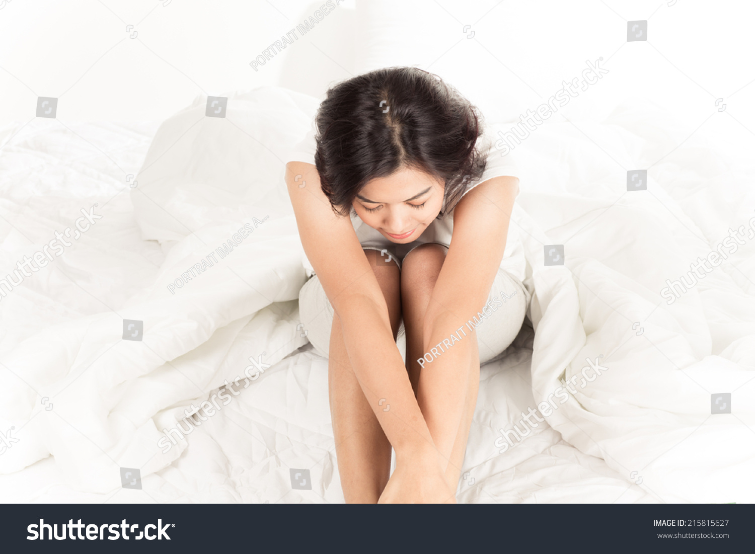 Portrait of a beautiful young woman in bed #215815627