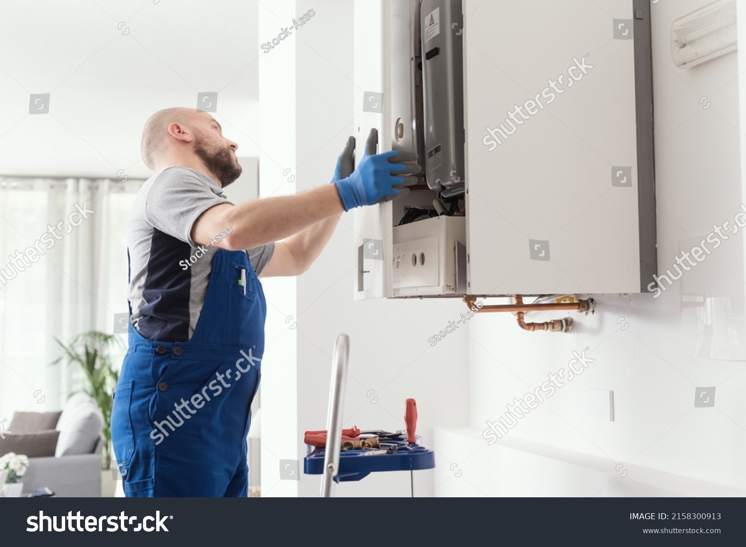 Professional engineer doing a boiler inspection at home #2158300913