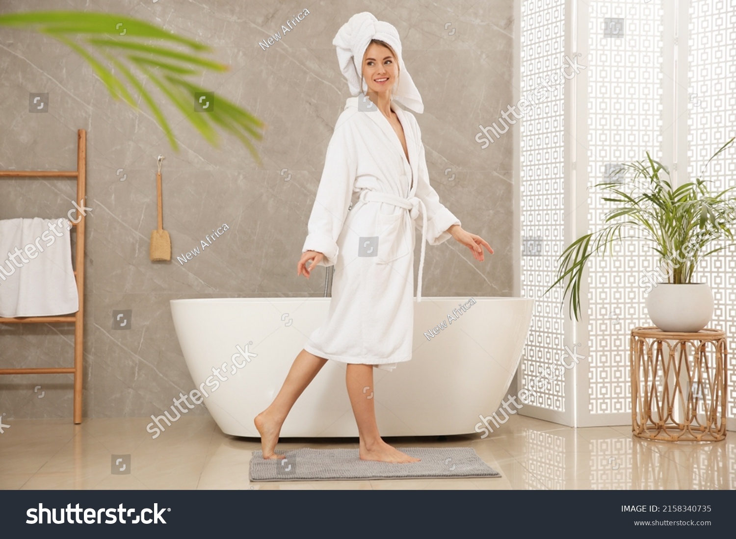 Beautiful woman wearing white robe in bathroom #2158340735