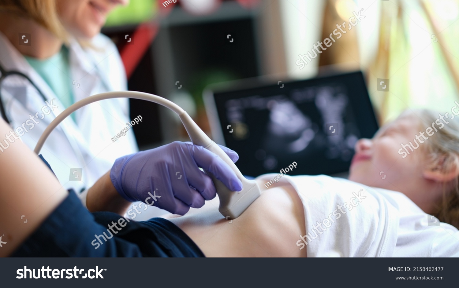 Doctor conducting ultrasound examination of internal organs of child in clinic. Diagnosis and treatment of diseases of liver and biliary tract in children concept #2158462477