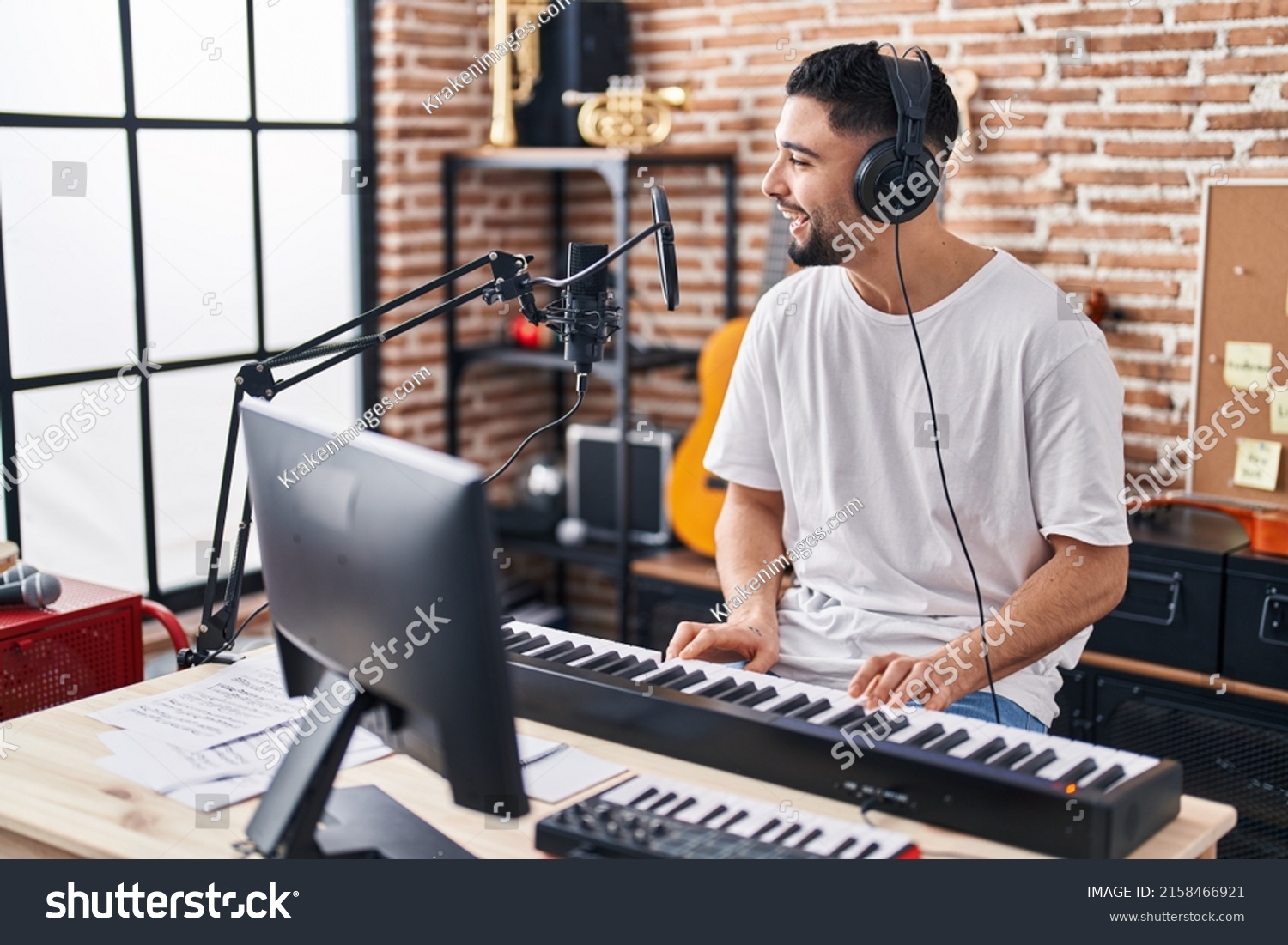 Young arab man musician playing piano keyboard at music studio #2158466921