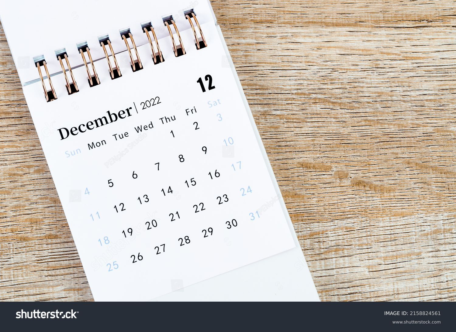 The December 2022 desk calendar on wooden background. #2158824561
