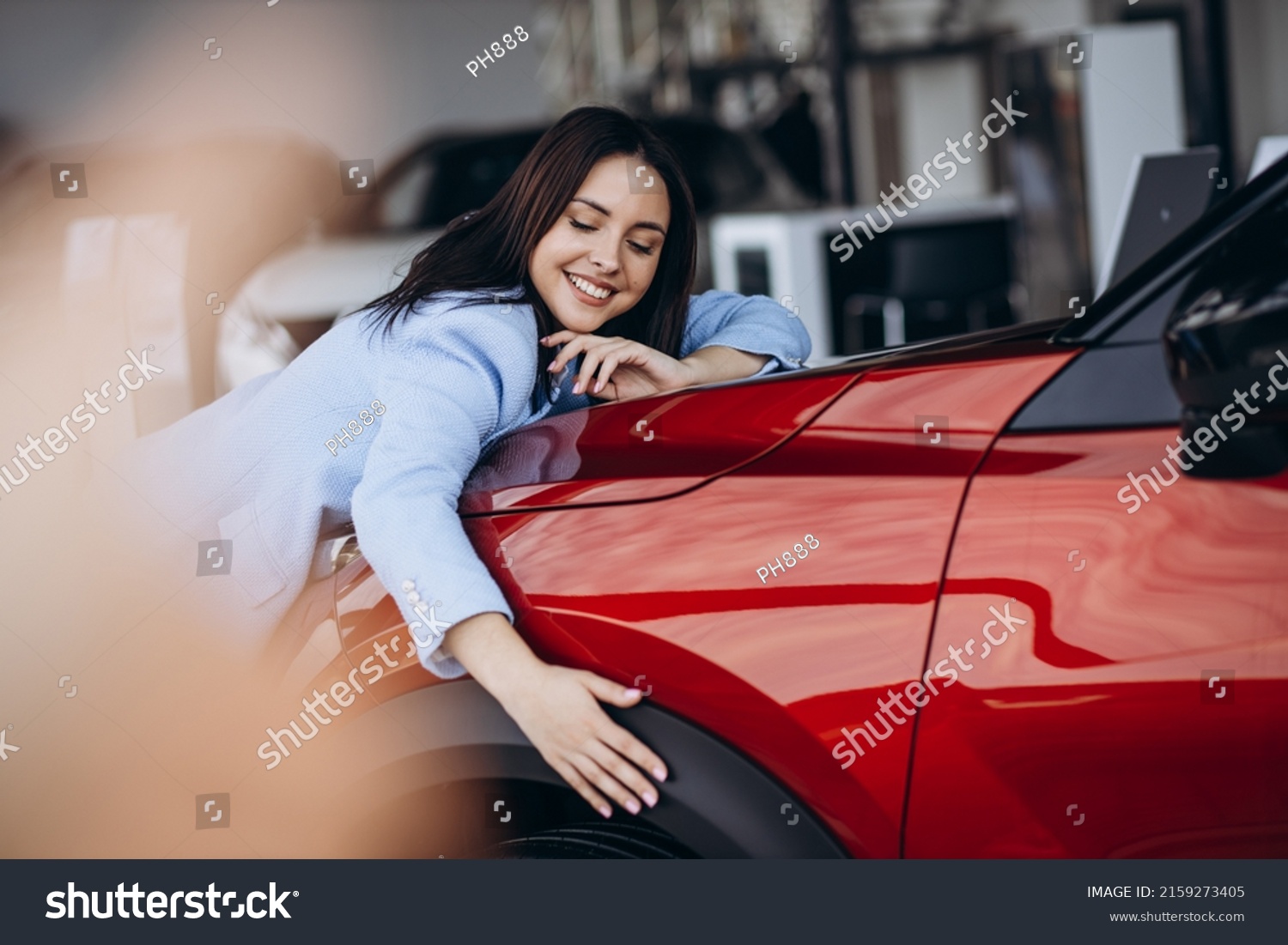 Woman hugging her new red car #2159273405